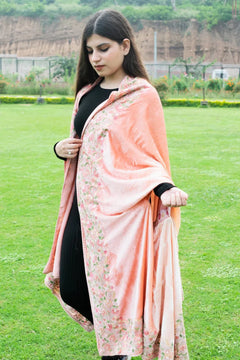 #Peach Woman holding a peach-colored floral shawl over her shoulders in an outdoor setting.