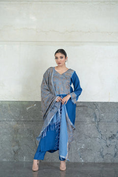 A woman modeling a floral embroidered straight kurta and pants set with a dupatta in a grey and blue color scheme.
#AquaBlue